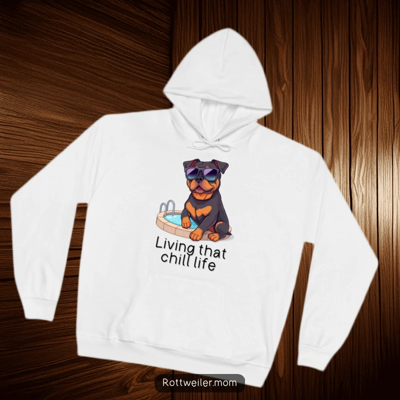 Funny Rottweiler Vacation Hoodie: A comfy hoodie featuring a rottweiler in sunglasses by a pool, ideal for relaxation.