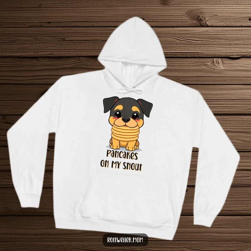 Funny Kawaii Rottweiler Hoodie showing a charming dog expertly balancing a wobbly tower of pancakes on its snout.