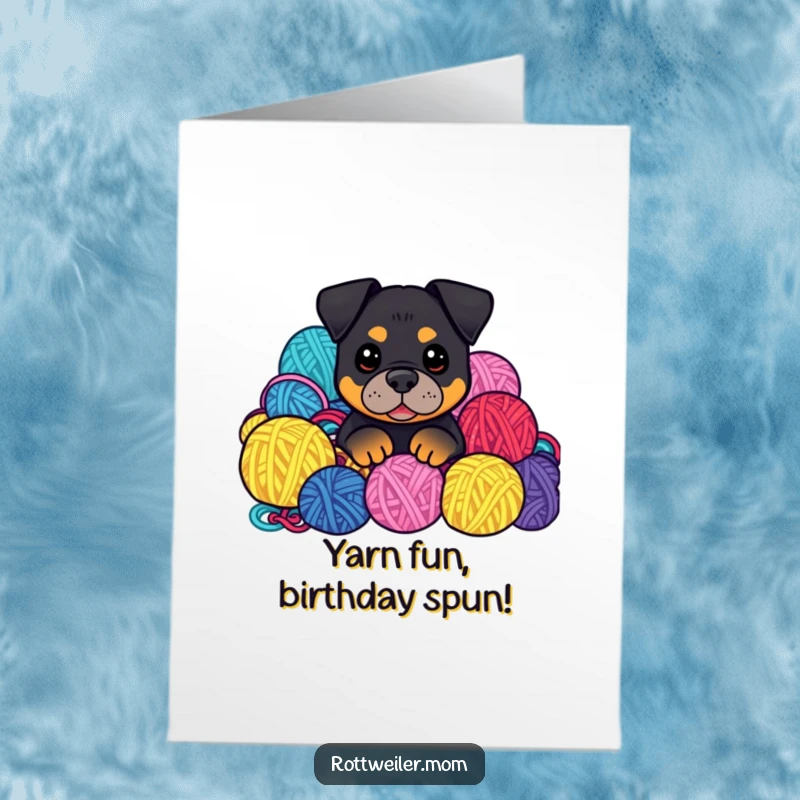 Funny Free Printable Birthday Card: Kawaii Rottweiler peeking from colorful yarn balls, adding a touch of cozy fun to birthday wishes.