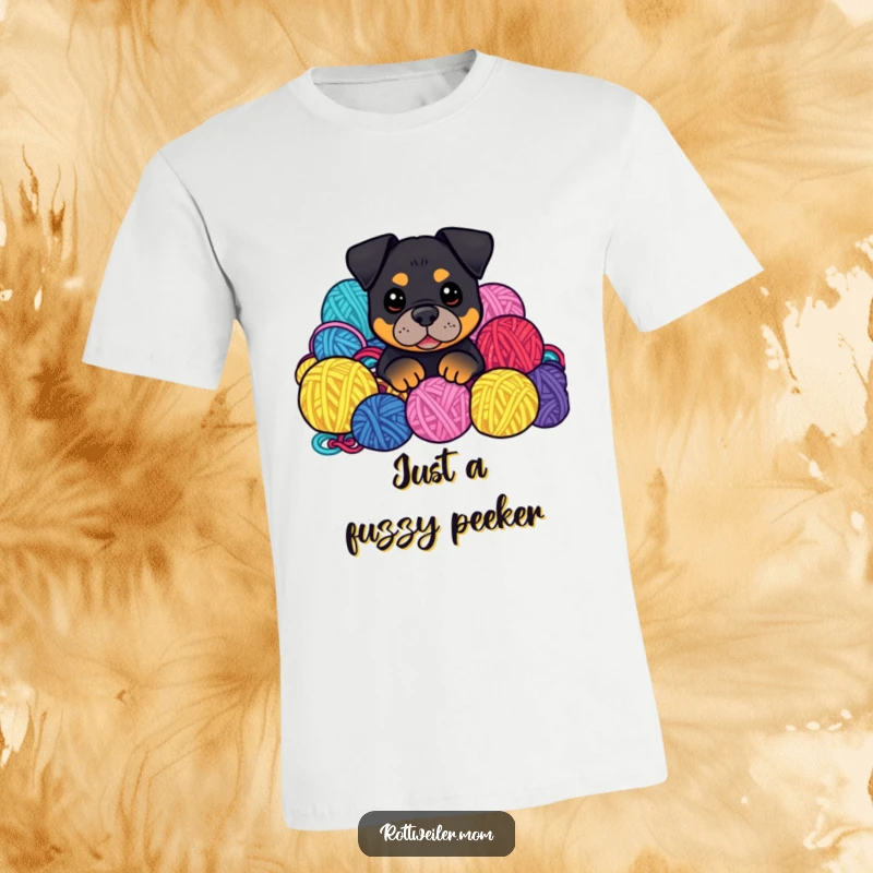 Funny Kawaii Rottweiler peeking from a vibrant pile of yarn balls on a t-shirt, a cute and humorous design.
