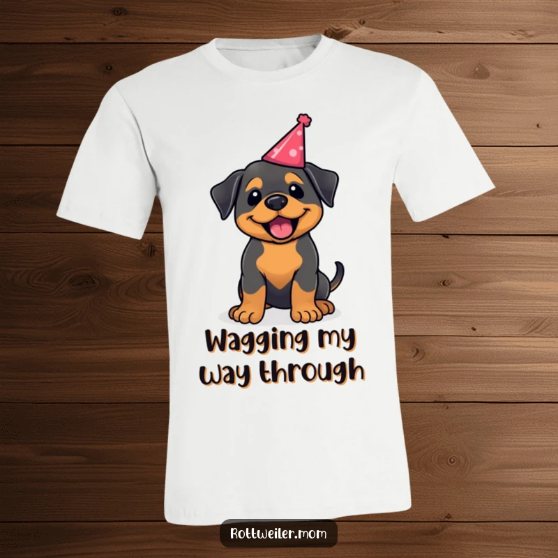 Funny kawaii Rottweiler t-shirt, a cute dog wagging its tail excitedly while wearing a party hat. Great for dog enthusiasts.