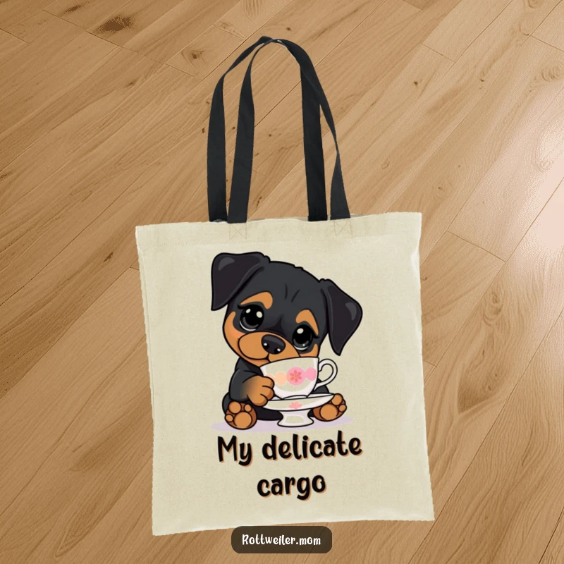 Funny tote bag with a kawaii Rottweiler with big eyes, precariously balancing a teacup, ideal for carrying items with humor.