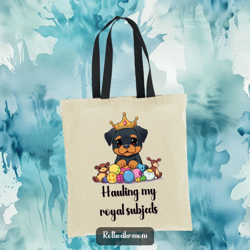 Funny Rottweiler Crown Tote Bag depicts a stately dog in a crown, gazing proudly at a heap of toys, perfect for a funny tote.